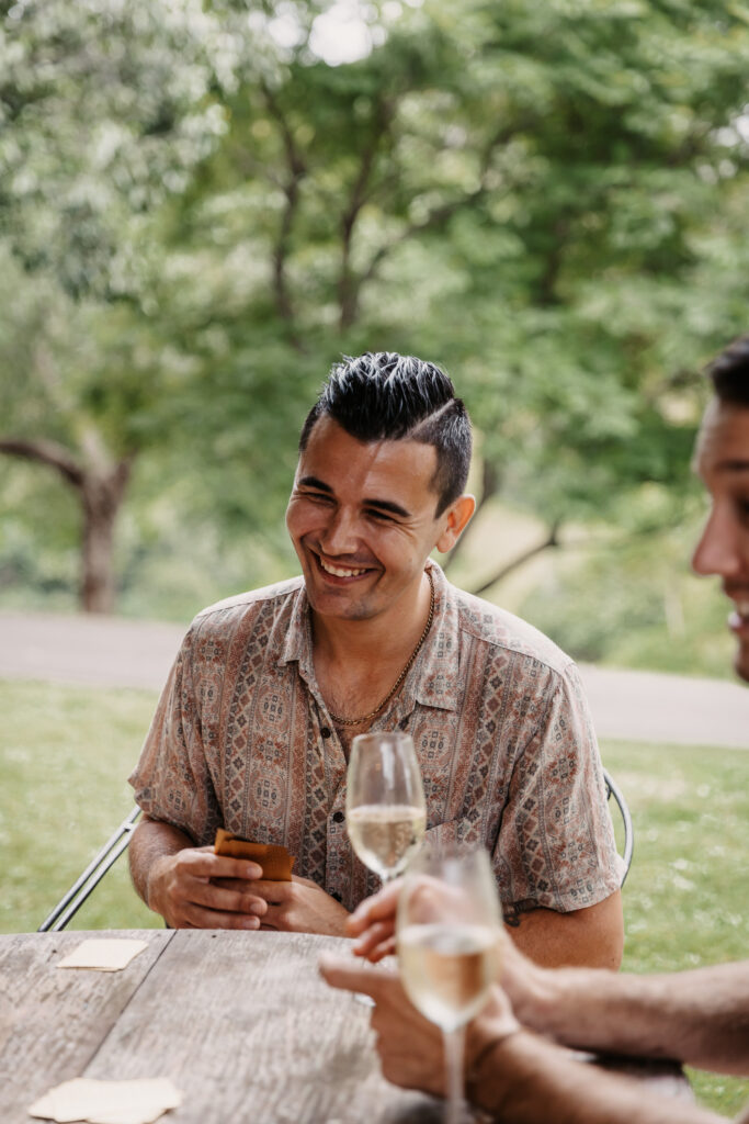 groom playing cards whilst getting ready at his wedding
