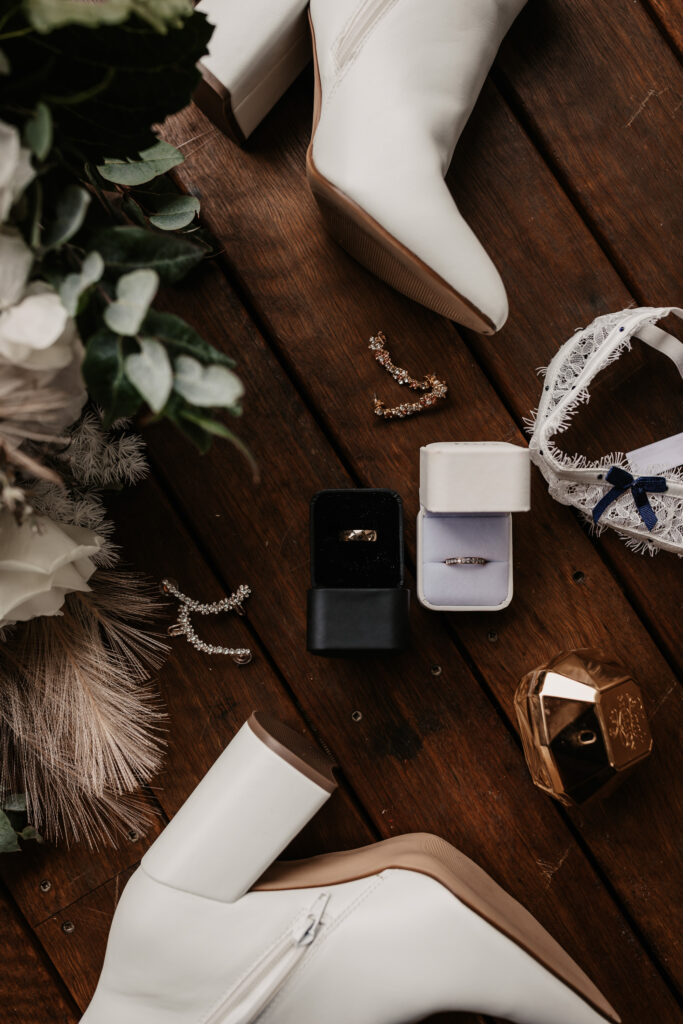 bride's accessories with wedding rings on the ground