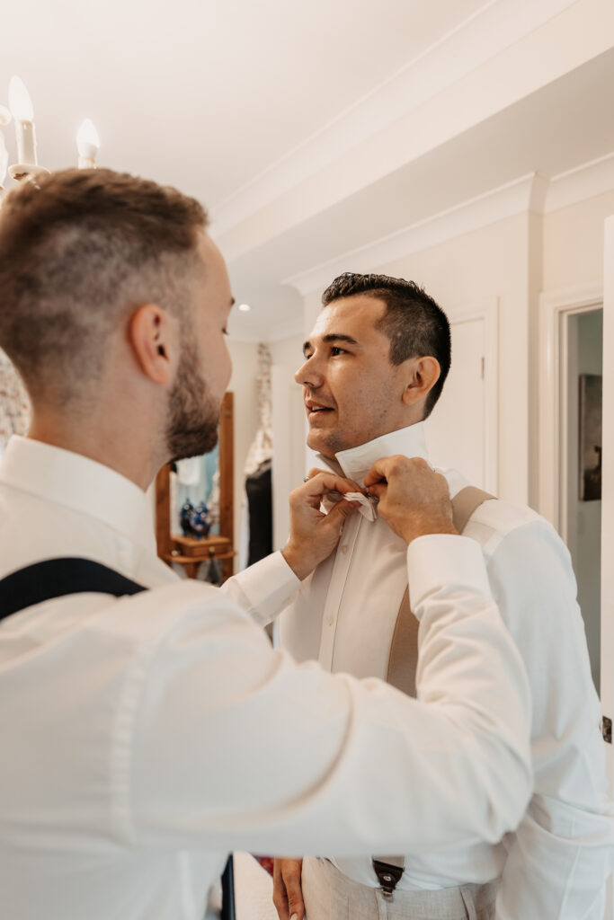 groom getting his bow tie adjusted