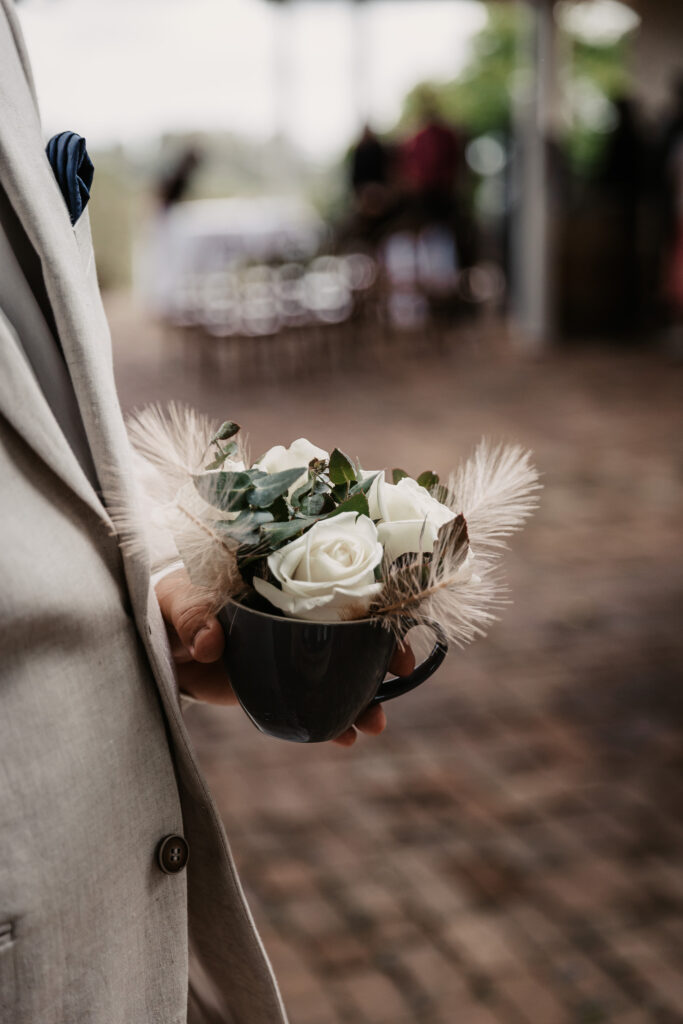 groom's boutonnieres in a vase