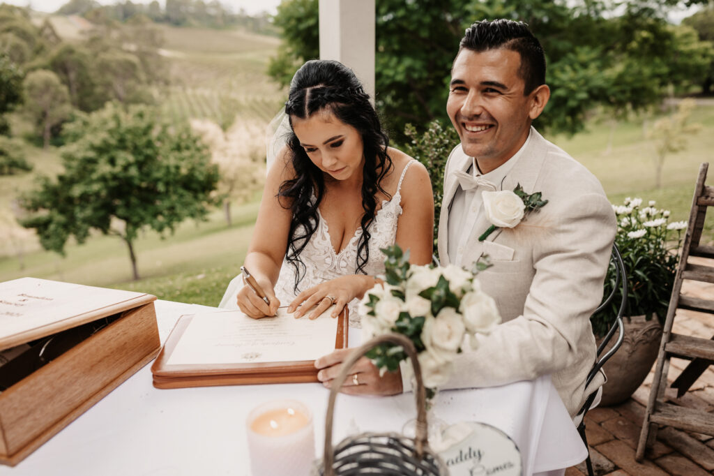 bride and groom signing their papers