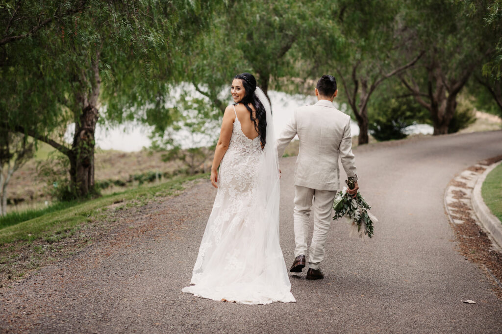 husband and wife holding hands walking away