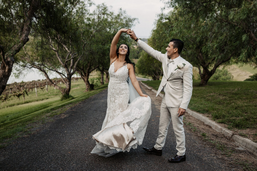 husband and wife dancing together on the road