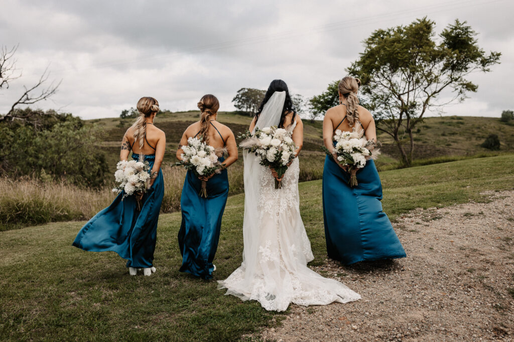 bridesmaids with the bride and their flowers