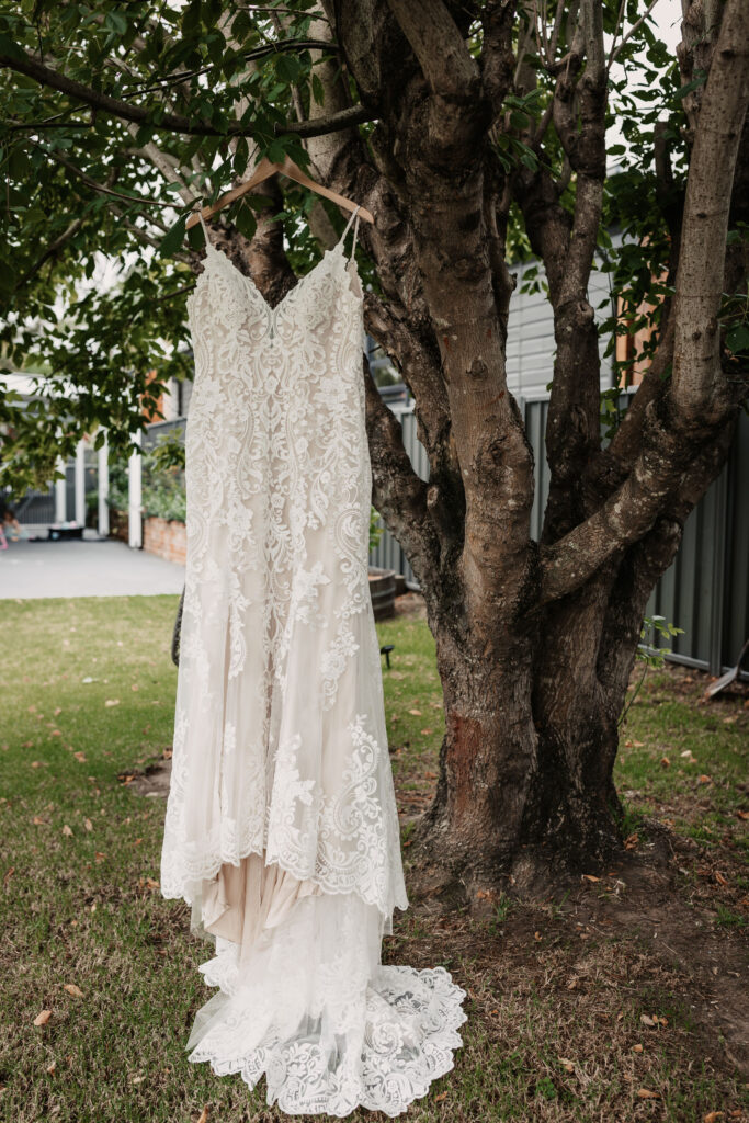 Bride's dress hanging up from a tree