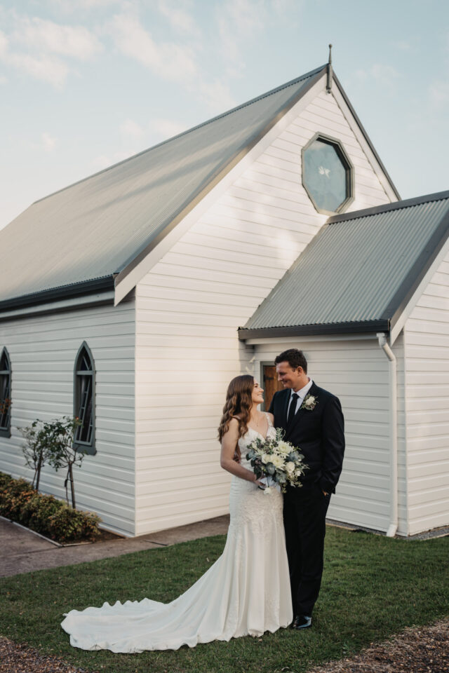 Husband and wife standing outside Lovedale wedding chapel in the hunter valley