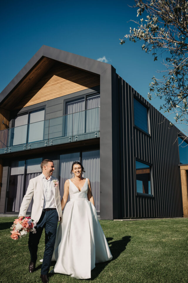 Husband and Wife walking with Seacliff house in the background