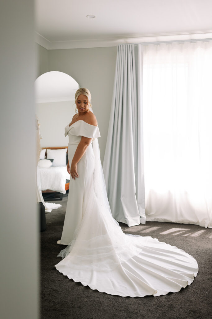 Bride in the mirror looking at her dress