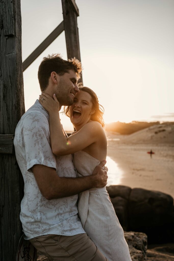 Couple kissing at Sunset Engagement Session on Redhead beach, NSW