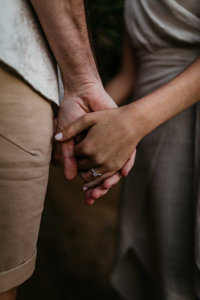 Holding hands at Sunset Engagement Session on Redhead beach, NSW