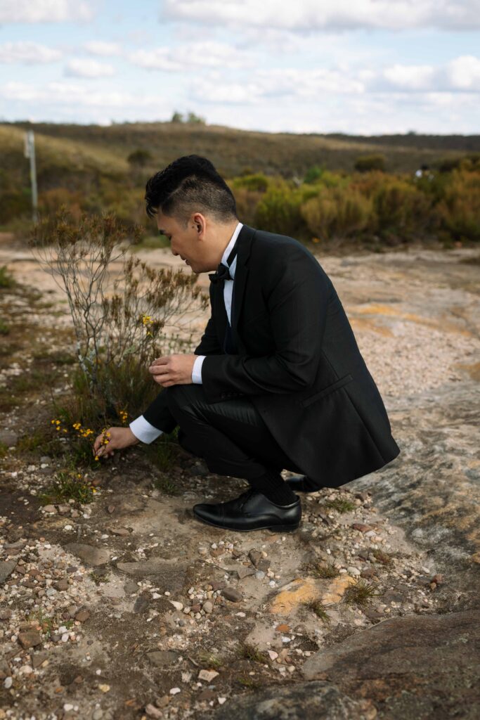 husband picking flowers for his wife at the blue mountains