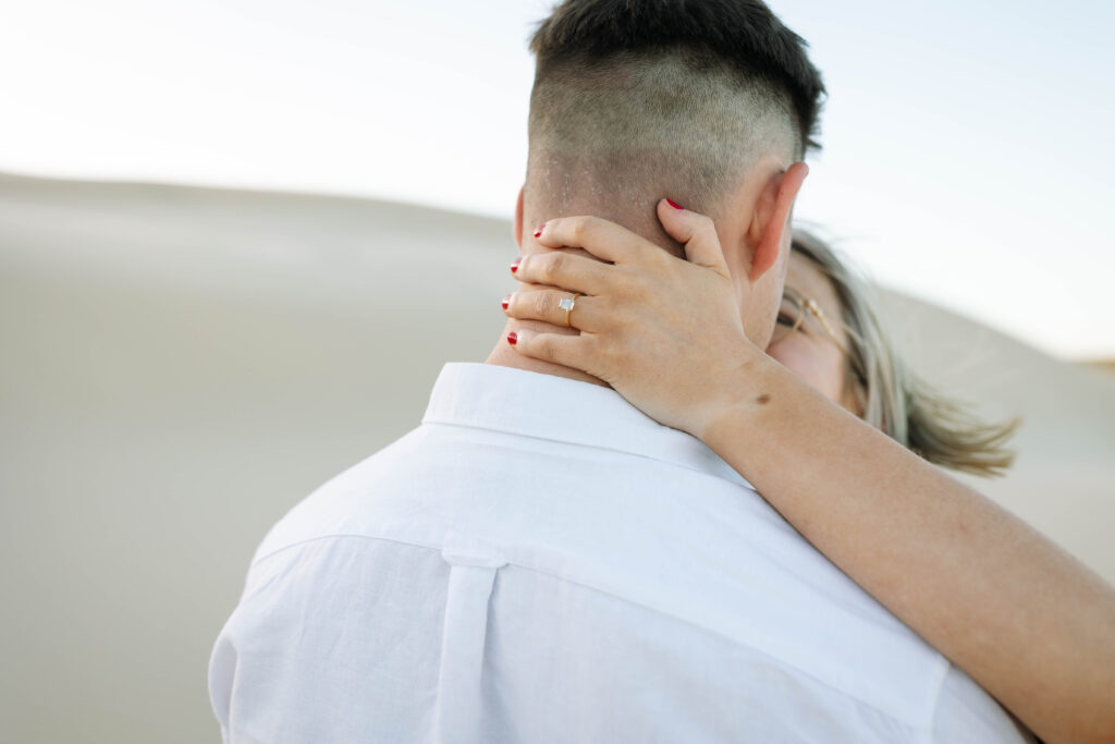 Engagement session sunset at Stockton sand dunes. Engagement ring