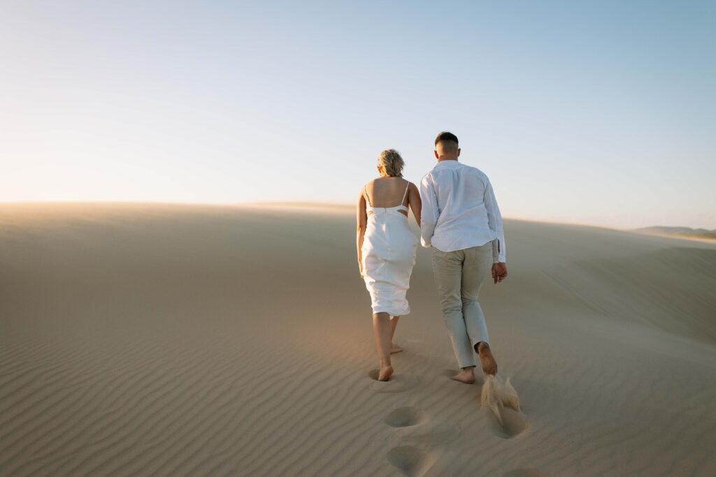 Engagement session sunset at Stockton sand dunes. Footprints in the sand