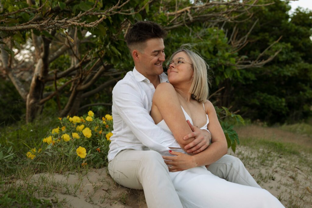 Engagement session sunset at Stockton sand dunes hugging each other
