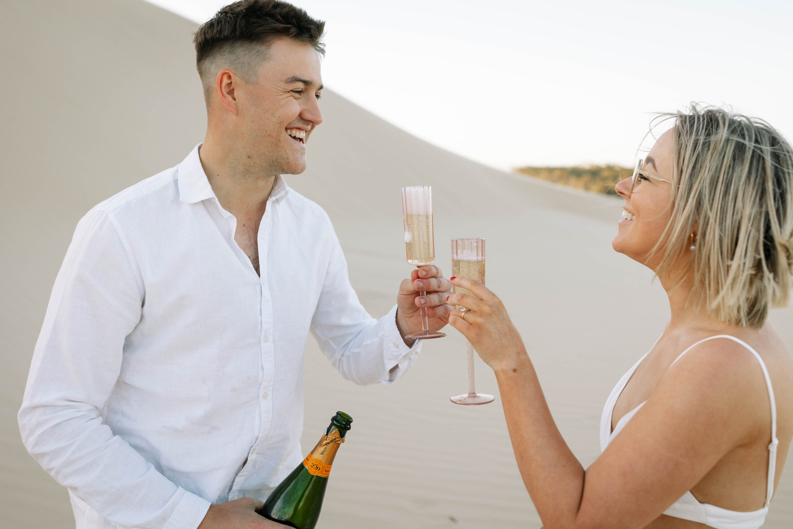 Couple celebrating with a bottle of Champaign