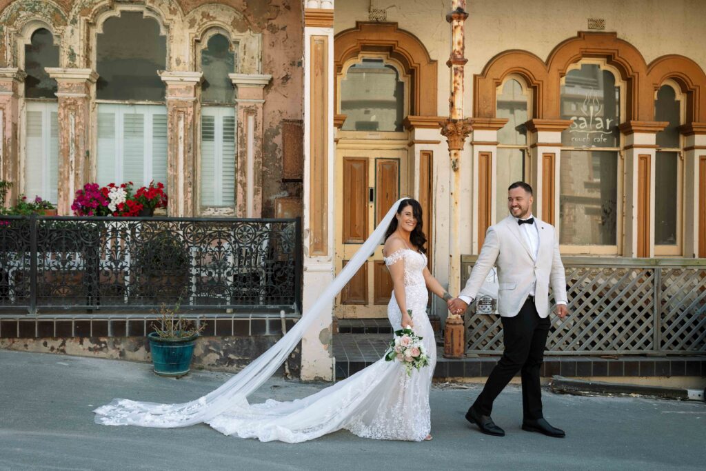 husband leading his wife down the street near some rustic buildings in Newcastle city centre