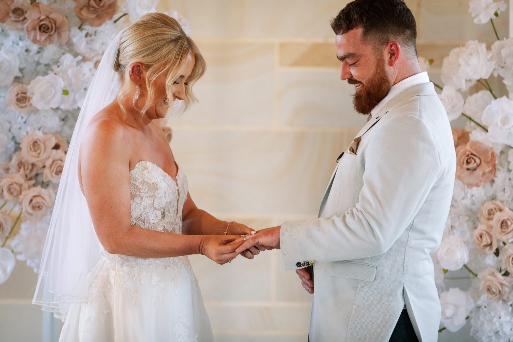 husband and wife getting married and exchanging rings in a chapel in the hunter valley