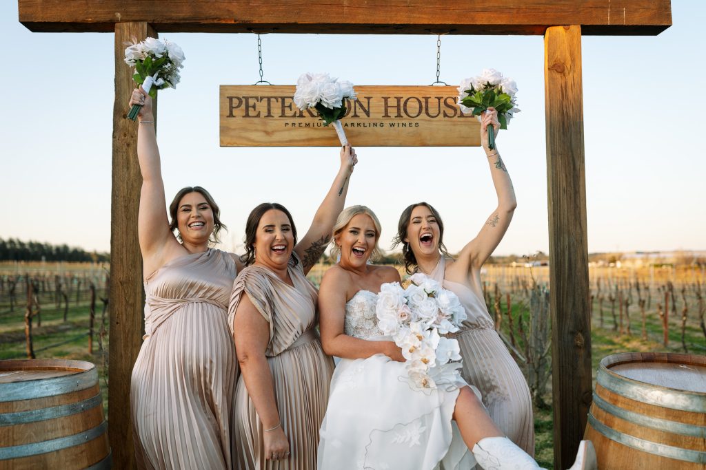 bridesmaids cheering with their flowers in the hunter valley