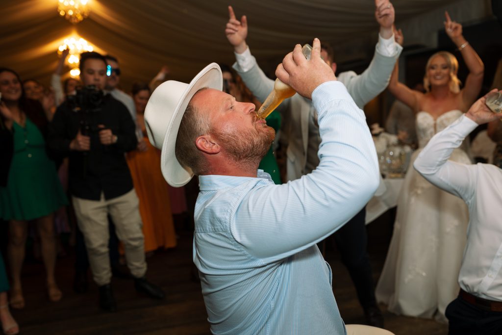 guest drinking beer at the reception at a wedding in the hunter valley