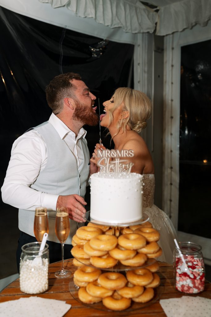 husband and wife cutting their donut cake at a wedding in the hunter valley