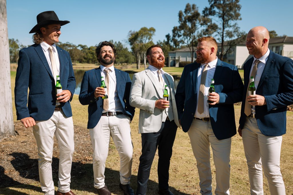 groom getting ready with groomsmen at his wedding drinking some beers in the hunter valley